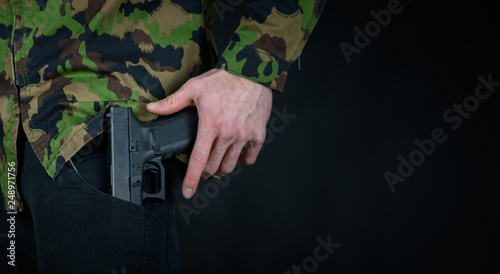 Soldier pulls weapon out of the bag