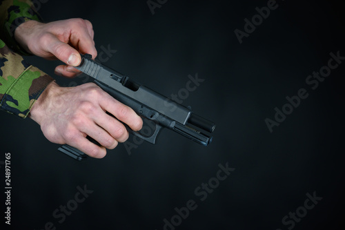Soldier is loading the gun in his hands