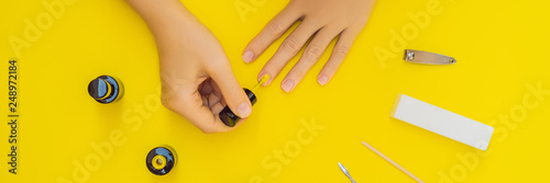 Woman Hands Care. Top View Of Beautiful Smooth Woman's Hands With Professional Nail Care Tools For Manicure On yellow Background. Closeup Of Healthy Female Nails With yellow Nail Polish. High