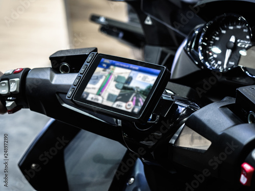 Motorcycle travel navigation on the handlebars of the bike, Finding a location on maps using the mobile on a smartphone.