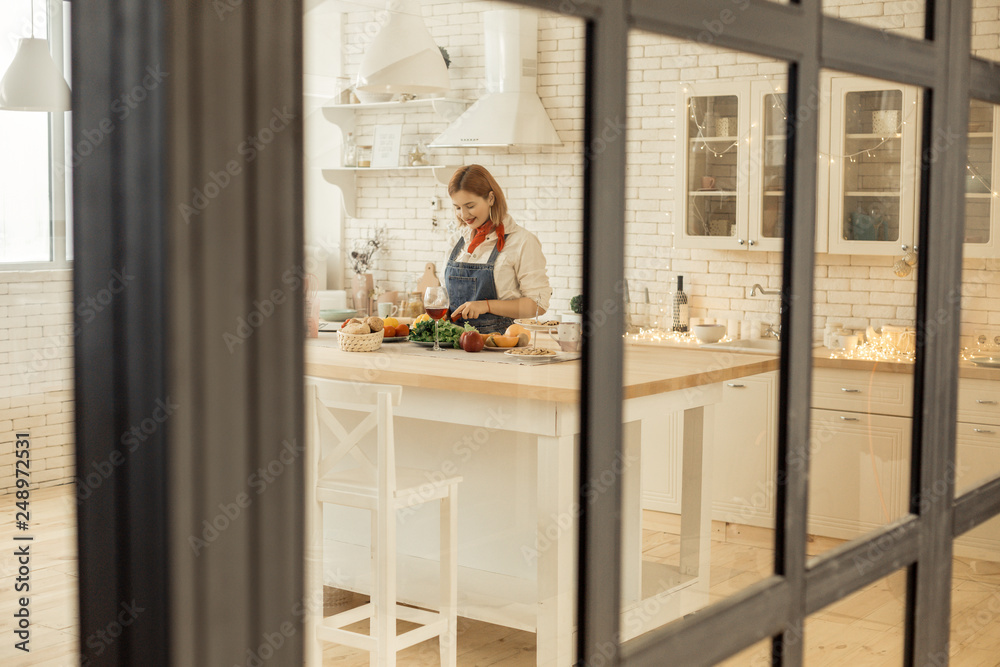 Red-haired young pretty girl with bright makeup making salad Red-haired young pretty girl with bright makeup making salad