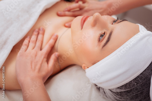 Face of an attractive young woman during spa procedure