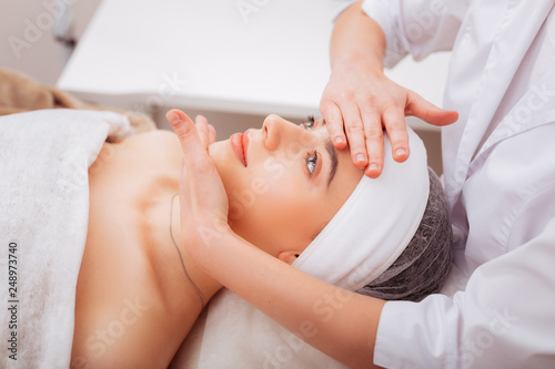 Nice young woman enjoying her facial massage