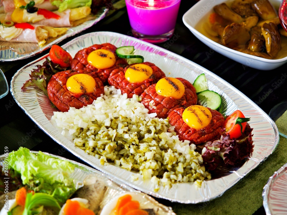 Beef tatare, tatar with egg, onion, cucumber and capers for party, traditional polish food. Beef tatare, tatar with egg, onion, cucumber and capers for party, traditional polish food.
