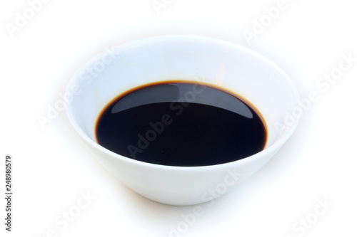 Soy sauce in a ceramic bowl isolated on white background, with clipping path