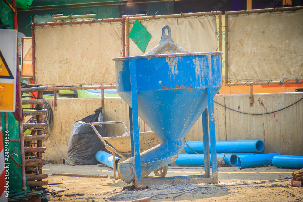 Blue concrete bucket, mixed cement container at the construction site