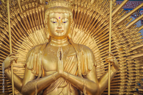 Golden statue of Guan Yin with 1000 hands. Guanyin or Guan Yin is an East Asian bodhisattva associated with compassion as venerated by Mahayana Buddhists and known as the 