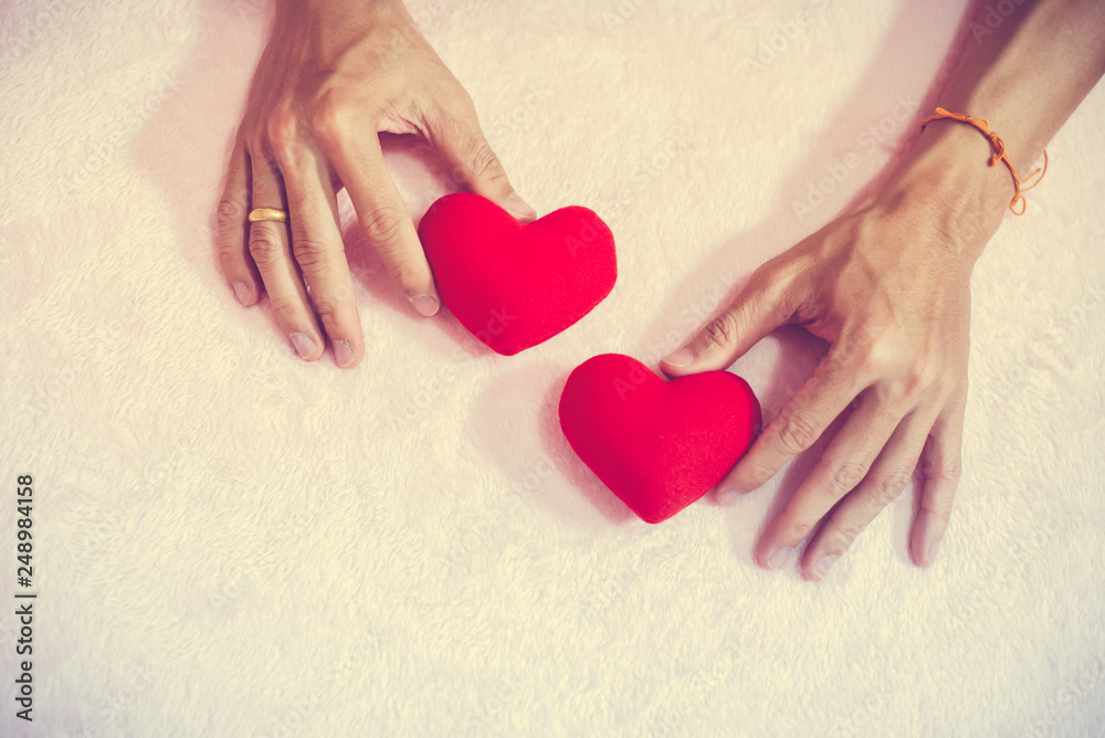 Fototapeta premium Top view hand holding red heart for valentine day concept, romantic love forever.
