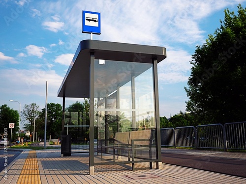 Fototapeta Naklejka Na Ścianę i Meble -  Bus tram stop, shelter, white empty place for street ads, advertisement board, mock up, mockup, signage, city, rails, rail station on glass.