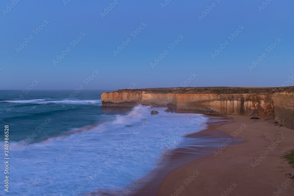 Ocean wave around the rock cliff. Dawn time view at Great Ocean Road, VIC, Australia.