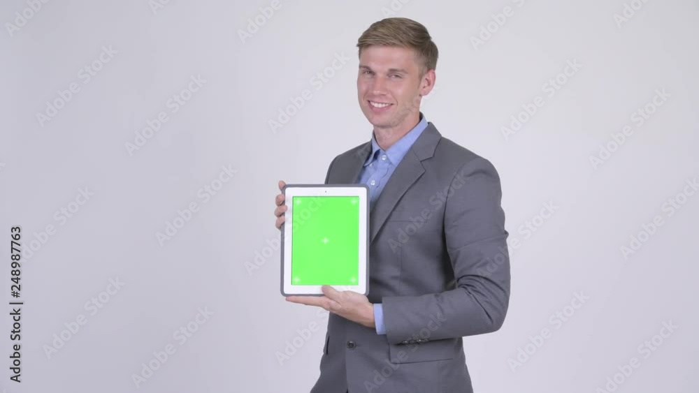 Happy young handsome businessman showing digital tablet Happy young handsome businessman showing digital tablet