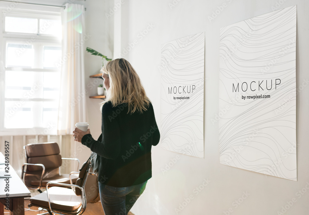 Woman in a working space with poster design mockups - obrazy, fototapety, plakaty 