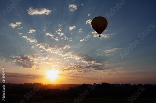 Hot air balloon flying at sunset