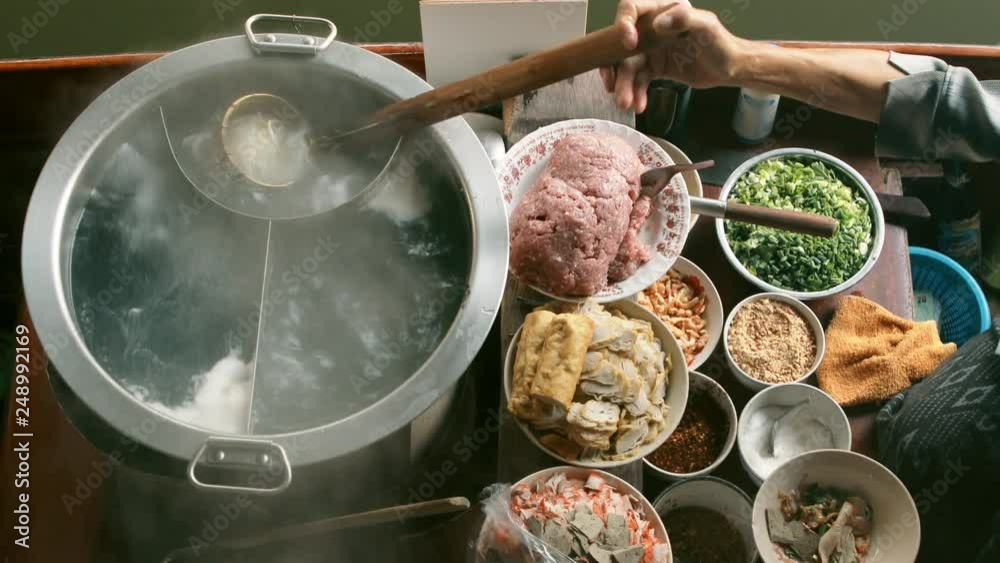 thai noodle food making on floating boat in floating market thailand