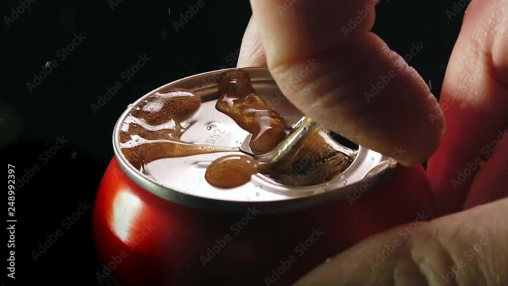 Opening a can of unbranded cola in slow motion.