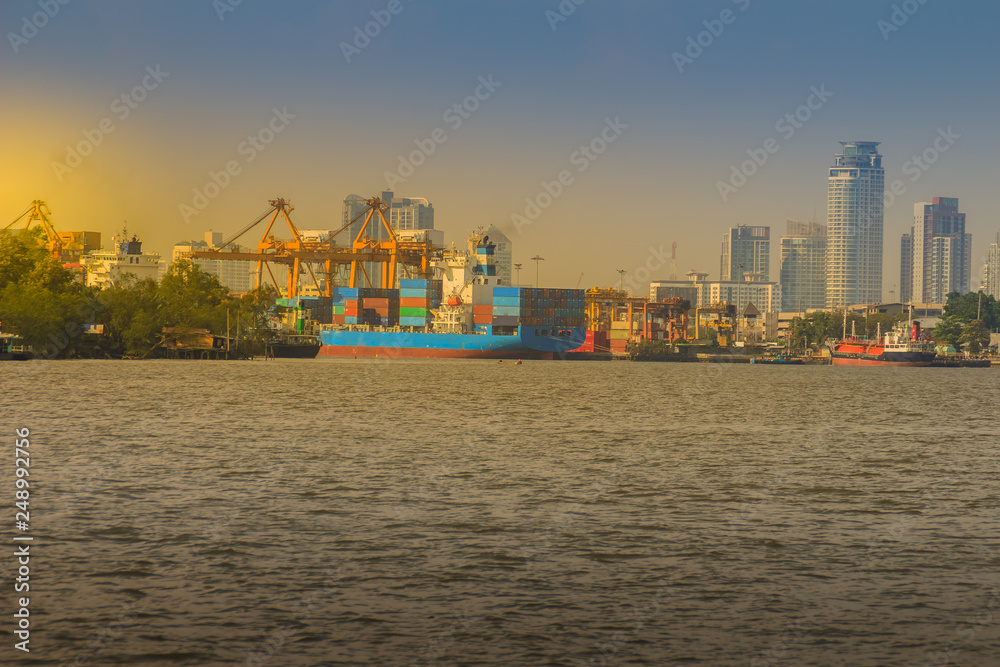 View of Bangkok Port Authority of Thailand or Klong Toey port along Chao Phraya river in Bangkok,Thailand. Heavy crane tool in ship port and container yard use for import and export.