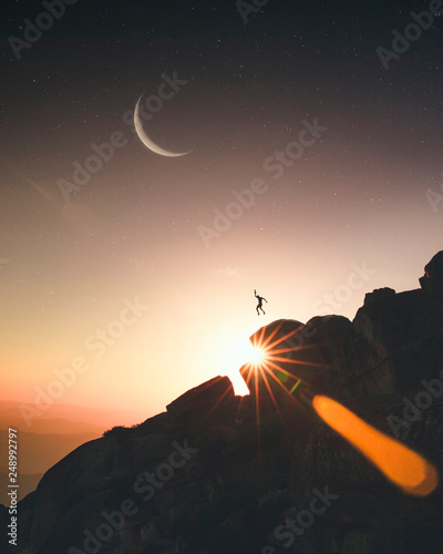 Person Jumping on Mountain Top at Sunset, Fantasy Conceptual Image