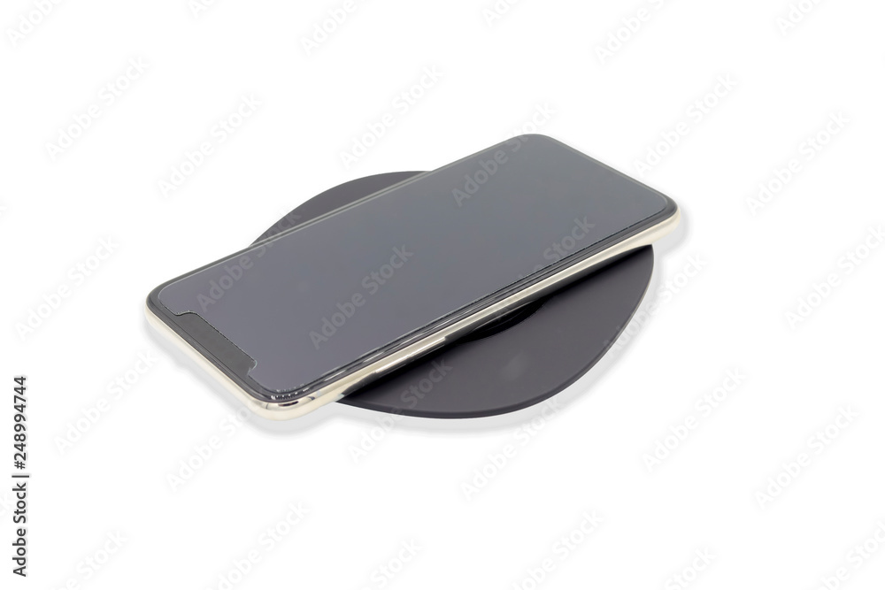 Smartphone on wifi charger isolated on white background.This has clipping path Smartphone on wifi charger isolated on white background.This has clipping path