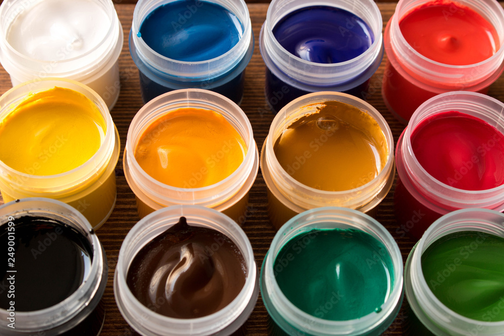 Various paints on the old wooden table . Creative concept Various paints on the old wooden table . Creative concept