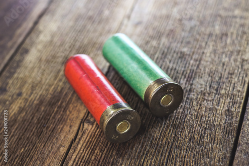 old hunting cartridges on a wooden background.