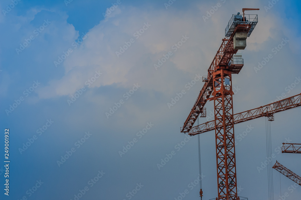 Yellow luffing jib tower crane against blue sky. Yellow luffing jib tower crane against blue sky.