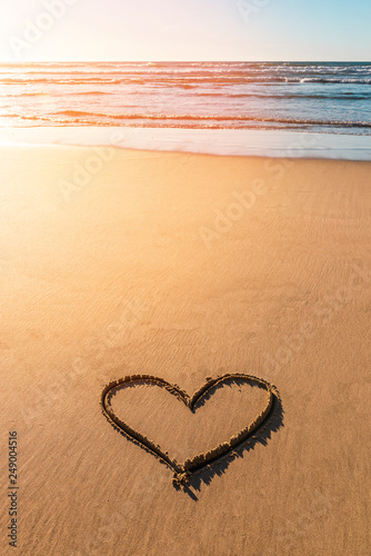 Heart drawn on sand near beautiful beach in valentines day.