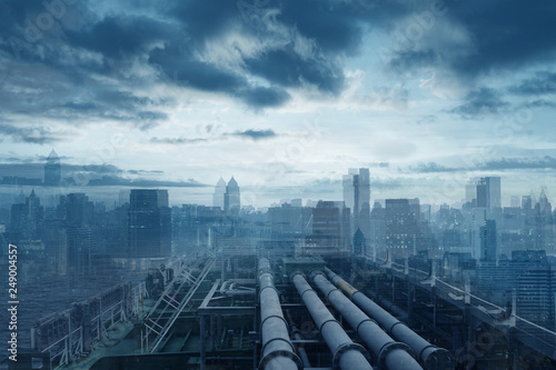 Industry reaching to city concept with pipe line gasoline and abstract city skyline at background in blue tone.
