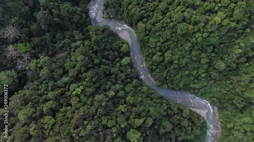 Aerial drone footage high above the rainforest canopy and Landak River in Bukit Lawang. Sequence 1 photo