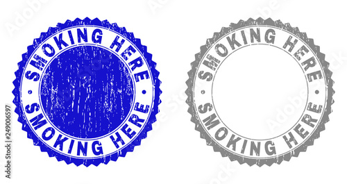 Grunge SMOKING HERE stamp seals isolated on a white background. Rosette seals with grunge texture in blue and grey colors. Vector rubber stamp imprint of SMOKING HERE text inside round rosette.