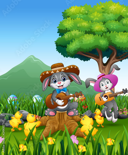 Cute bunnies relax playing guitar with a nature background