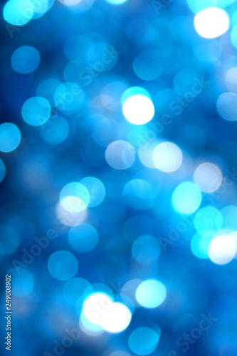abstract blurred glowing light particles of shades of blue