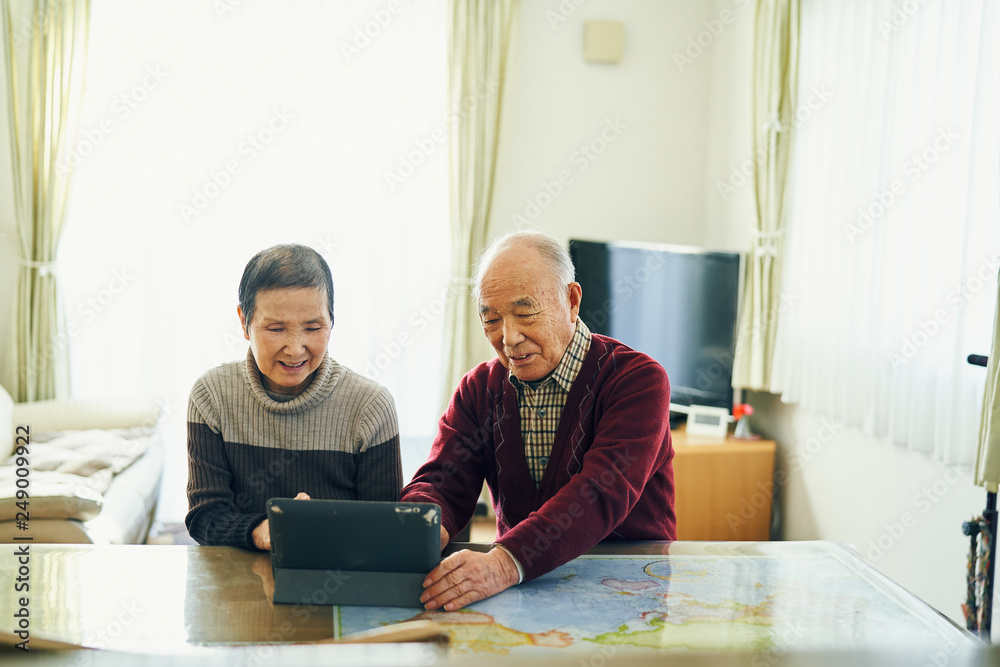 Senior couple using digital tablet at home Senior couple using digital tablet at home