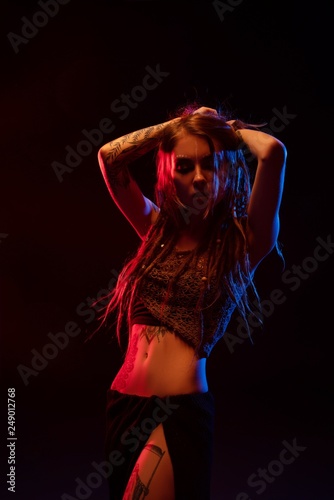 Dancing girl with henna bodyart and dreadlocks