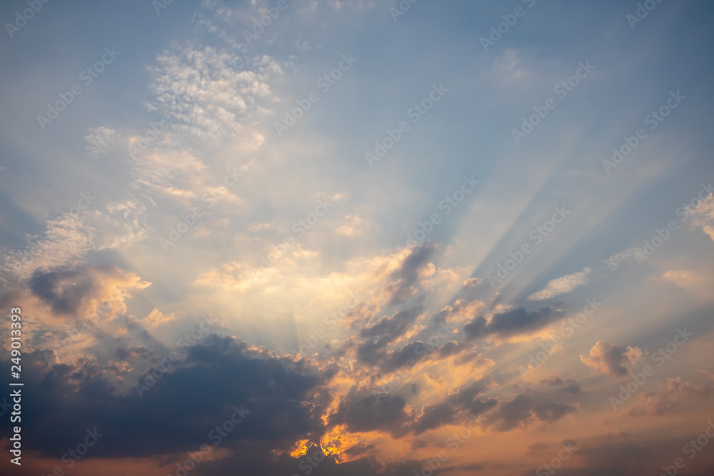 Blue and orange sunset sky with rays of sun. Natural landscape for background Blue and orange sunset sky with rays of sun. Natural landscape for background