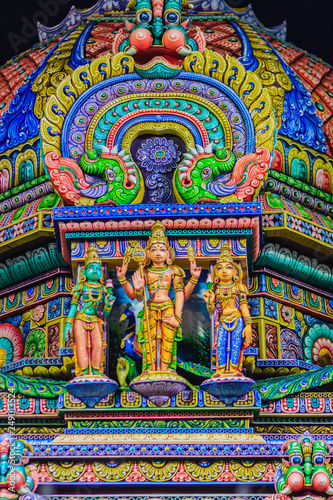 Colorful night view of indian gods sculpture at Sri Maha Mariamman Temple, also known as Maha Uma Devi temple, the public hindu temple in Silom, Bangkok, Thailand. It known as Wat Khaek Silom.