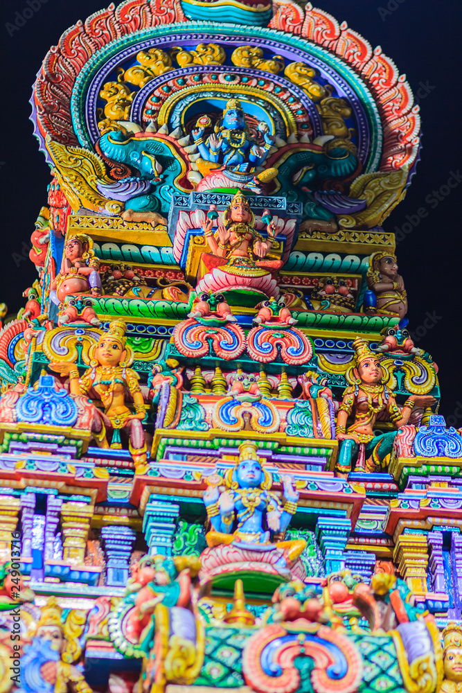 Fototapeta premium Colorful night view of indian gods sculpture at Sri Maha Mariamman Temple, also known as Maha Uma Devi temple, the public hindu temple in Silom, Bangkok, Thailand. It known as Wat Khaek Silom.