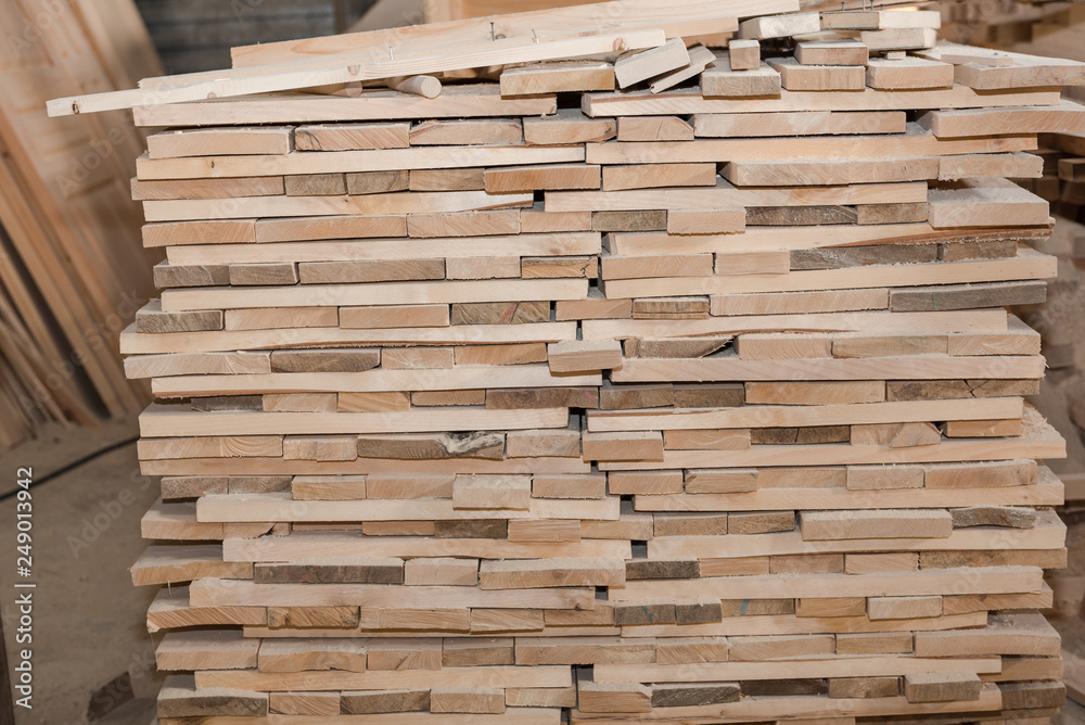 Wooden boards in a stack. Pine boards. A lot of lumber. Wooden boards in a stack. Pine boards. A lot of lumber.