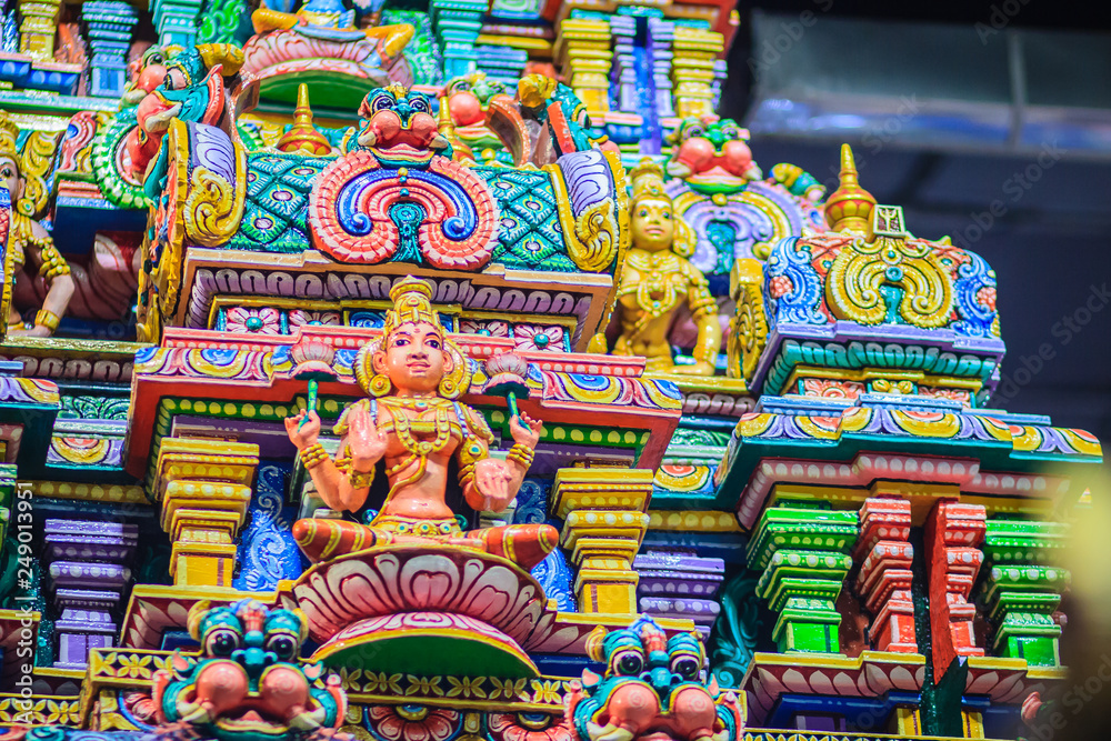 Colorful night view of indian gods sculpture at Sri Maha Mariamman Temple, also known as Maha Uma Devi temple, the public hindu temple in Silom, Bangkok, Thailand. It known as Wat Khaek Silom.