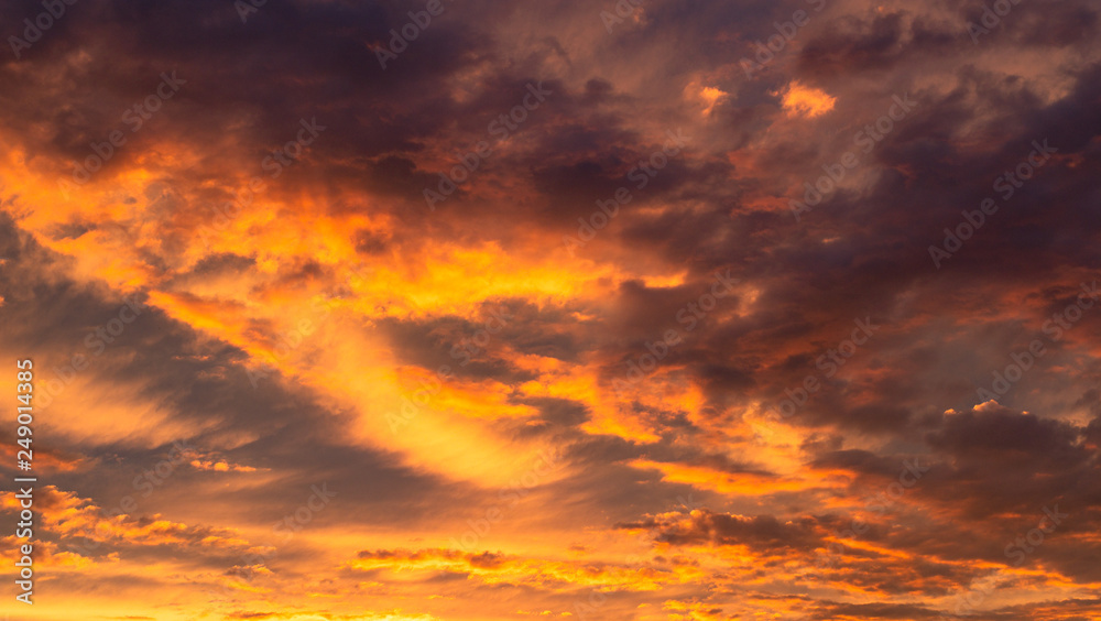 Colourful clouds at sunset. Dramatic exploding sunset. Fiery Sky. Beautiful stormy sky. Cloudy abstract background. Sunset colors.