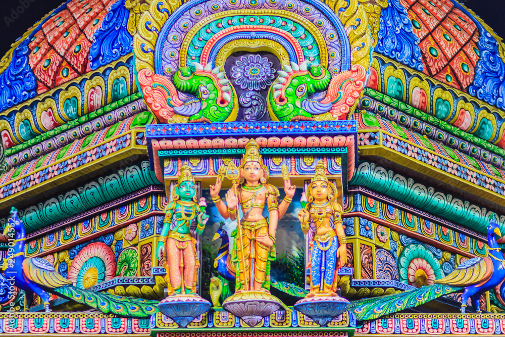 Colorful night view of indian gods sculpture at Sri Maha Mariamman Temple, also known as Maha Uma Devi temple, the public hindu temple in Silom, Bangkok, Thailand. It known as Wat Khaek Silom.