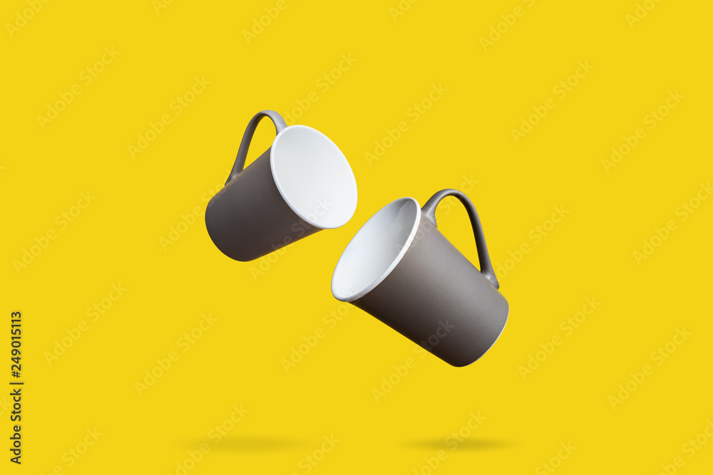 Flying Concept of Red Coffee Tea Cup on Yellow Background