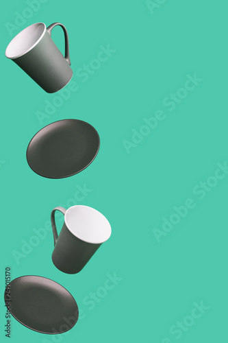 Flying Concept of Red Coffee Tea Cup and Plate on Green Background