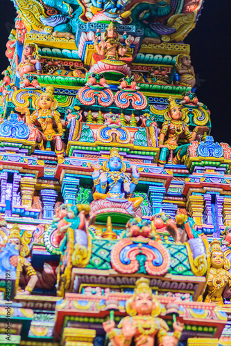 Colorful night view of indian gods sculpture at Sri Maha Mariamman Temple, also known as Maha Uma Devi temple, the public hindu temple in Silom, Bangkok, Thailand. It known as Wat Khaek Silom.