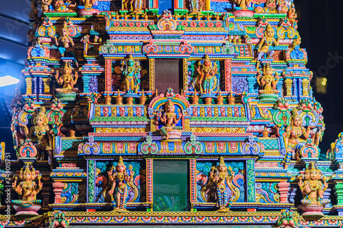 Colorful night view of indian gods sculpture at Sri Maha Mariamman Temple, also known as Maha Uma Devi temple, the public hindu temple in Silom, Bangkok, Thailand. It known as Wat Khaek Silom. © kampwit