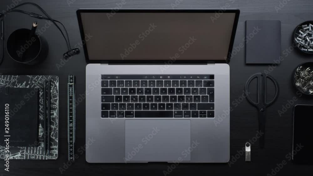 Male hands typing laptop on black clean minimalistic table with top view, gestures and finger movements Male hands typing laptop on black clean minimalistic table with top view, gestures and finger movements
