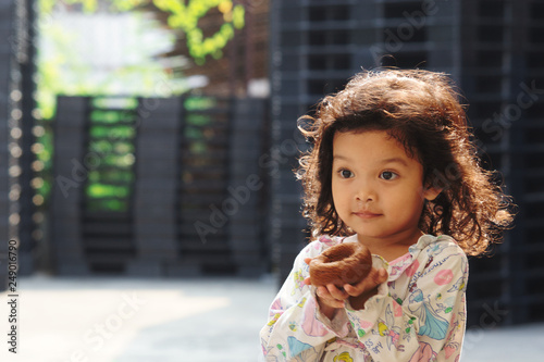 portrait of a girl in front of brick wall