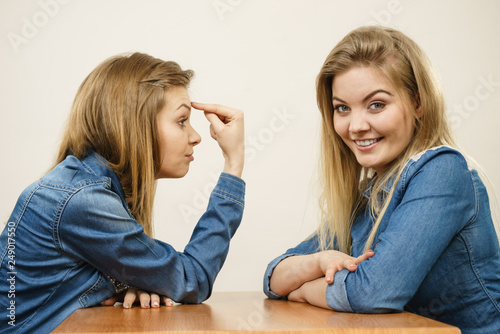 Woman mocking her confident friend