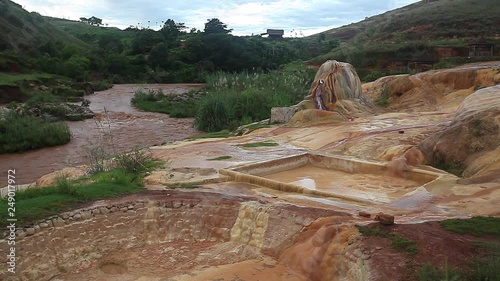 Analavory geysers with the red mineralized soil. Madagascar photo