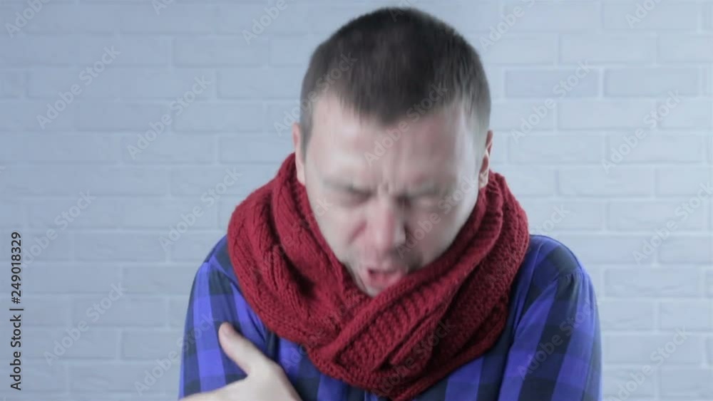 young man having cold on a wall young man having cold on a wall