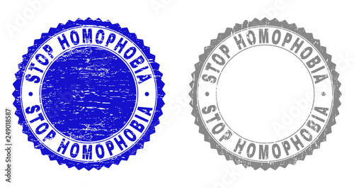 Grunge STOP HOMOPHOBIA stamps isolated on a white background. Rosette seals with grunge texture in blue and gray colors. Vector rubber stamp imitation of STOP HOMOPHOBIA caption inside round rosette.
